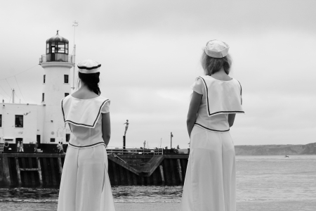 sailor girls in uniform looking out to seaの写真素材