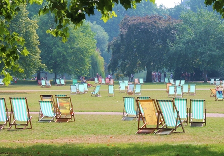 Striped deck chairs in park on grass - Stock Photoの写真素材