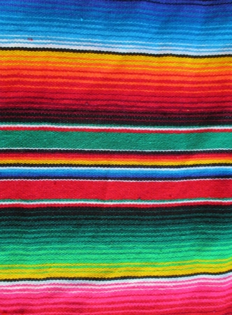 mexican handwoven rug poncho fiesta with stripes and bright colorsの写真素材