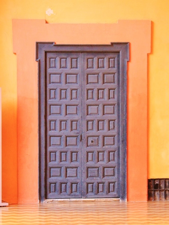 door with tiles and orange painted doorwayの写真素材