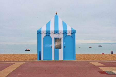 Vintage retro striped beach tent marquee on shingle pebblesの写真素材