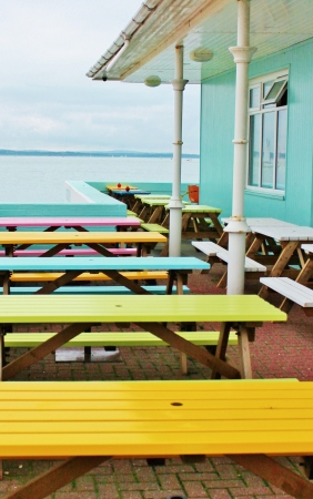 bright cafe tables by seasideの写真素材