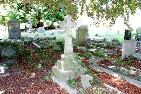 Tombstone and graves in an ancient church graveyard 