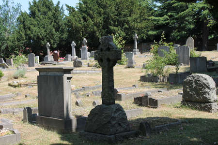 Tombstone and graves in an ancient church graveyard 