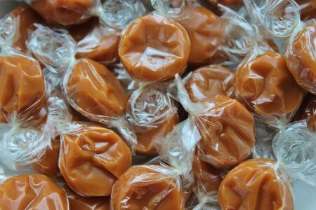 chewy toffee caramels in wrapperの写真素材
