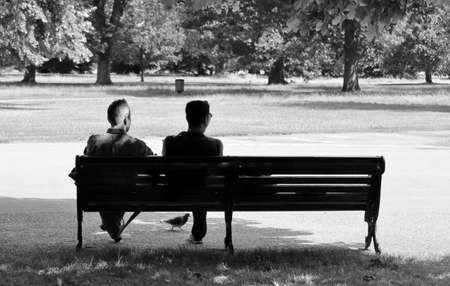 men talking on benchの写真素材