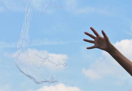 hand reach Bubbles against the sky