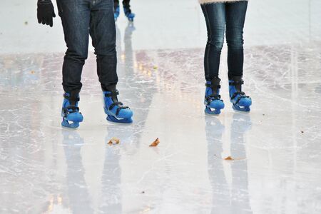 Ice Skater boots on ice rink with leavesの写真素材