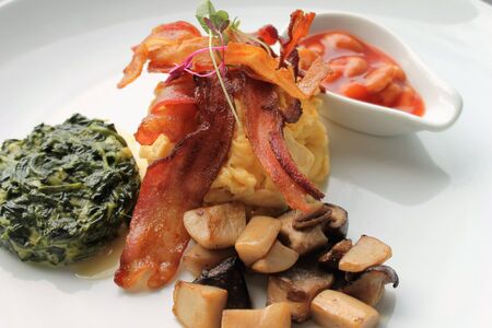 a la carte breakfast bacon scrambled eggs baked beans creamed spinachの写真素材