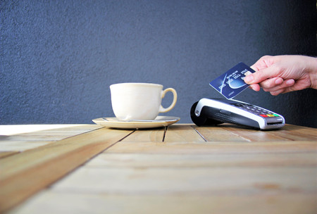 contactless payment card pdq background copy space with hand holding credit card ready to payの写真素材