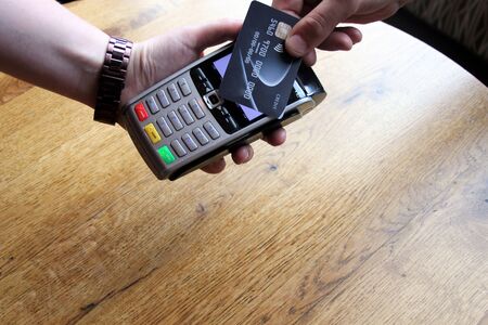 contactless payment card pdq background copy space with hand holding credit card ready to payの写真素材