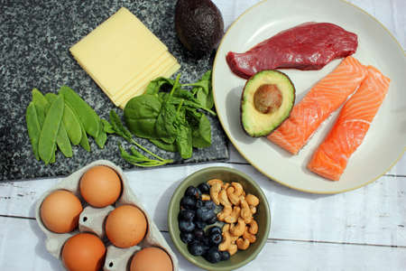 keto or ketogenic low carb atkins paleo style diet protein based meat fish dairy eggs veg berries and nutsの写真素材