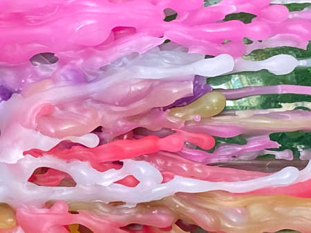 abstract background of multicolored paint splashes close-upの写真素材