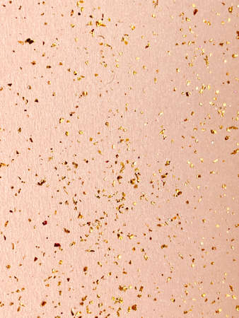 Gold glitter on a pink background. Festive abstract background. Copy space.の写真素材