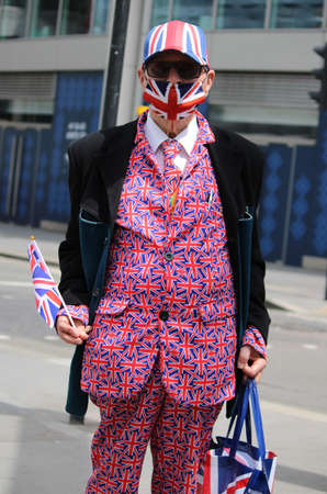 Unidentified man in a red striped suit and sunglasses with a United Kingdom flag on his shoulder.の写真素材