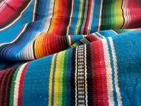 A closeup shot of a colorful striped rug with a blurry background