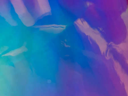 abstract background of blue and pink holographic foil with a gradient