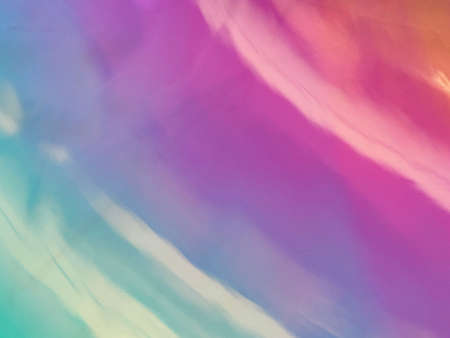 abstract background of holographic foil in pastel pink and blue colors