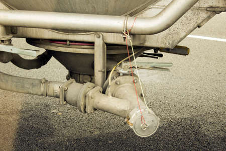 A mechanical grain dump mechanism on the belly of a semi-truck