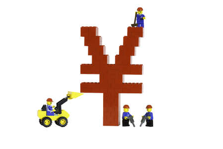 A red Chinese Yuan symbol constructed from toy bricks by model figures and shot against a white background at an angle to show it's 3D nature.  Growth of the Chinese economy.の写真素材