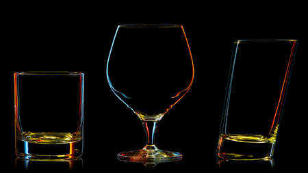 Silhouette of multicolor different glasses on black backgroundの写真素材