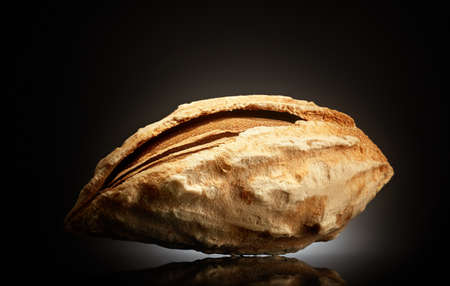 Almond on black background with reflection. Close-up or macro. Health concept