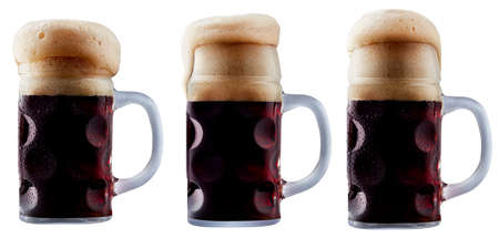 Mug of frosty dark beer with foam isolated on a white backgroundの写真素材