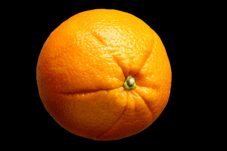 Fresh orange fruit isolated on black background.