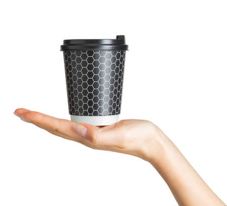 Woman hand holding coffee paper drinking cup with disposable top cap on white background. Isolated with clipping path.の写真素材
