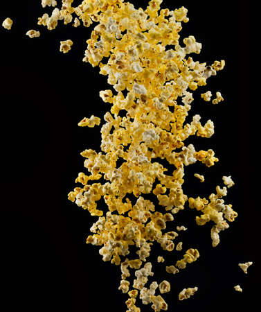 Flying popcorn isolated on blackの写真素材