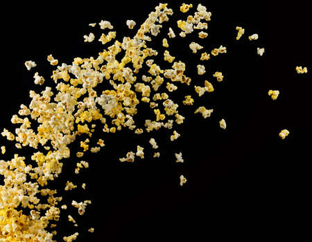 Flying popcorn isolated on blackの写真素材
