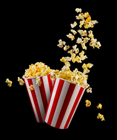 Set of paper striped buckets with popcorn isolated on black background, concept of watching TV or cinema.の写真素材