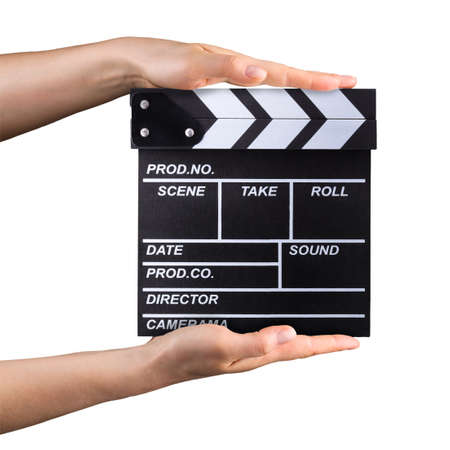 Human hand holding film clapper board isolated on whiteの写真素材