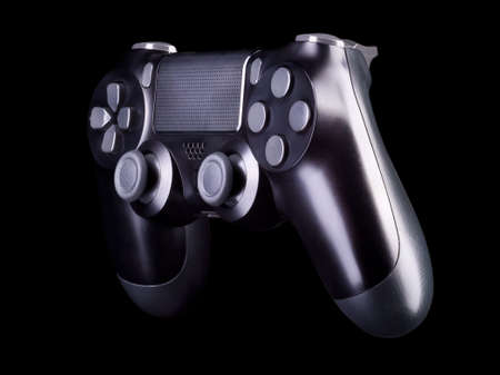 Black video game joystick gamepad isolated on a black background with clipping pathの写真素材