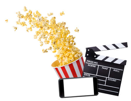Flying popcorn, film clapper board and phone isolated on white background, concept of watching TV or cinema.の写真素材