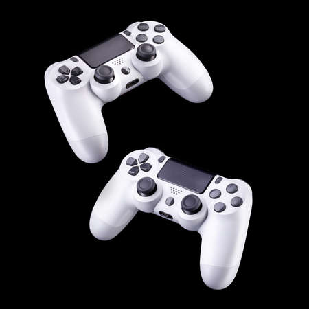 Set of white video game joysticks gamepad isolated on a black background, concept of playing games...