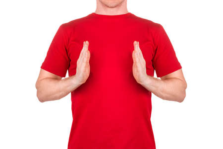 Front view of confident male in red t-shirt show something of small size isolated white background with clipping path. Concept of t shirt template and mock-up for printの写真素材