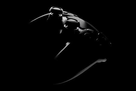 Realistic video game controller in noir lights on black table background. 3D rendering of streaming gear and virtual reality conceptの写真素材