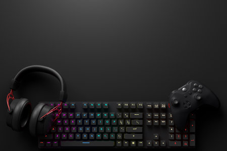 Top view of gamer workspace and gear like mouse, keyboard, joystick, headset, VR Headset on black...
