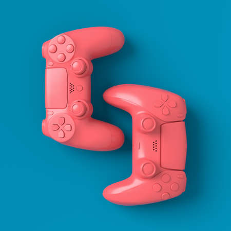 Set of lying gamer joysticks or gamepads on blue and pink backgroundの写真素材