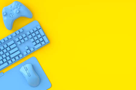 Top view of gamer workspace and monochrome blue gear like mouse, keyboard, joystick on yellow table background. 3d rendering of accessories for live streaming concept top viewの写真素材