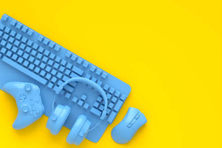 Top view of gamer workspace and monochrome blue gear like mouse, keyboard, joystick, headset on yellow table background. 3d rendering of accessories for live streaming concept top viewの写真素材