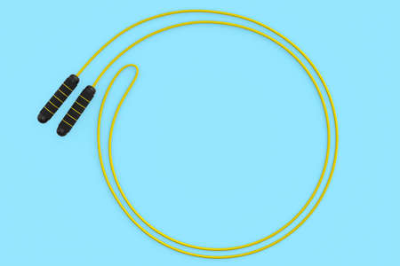 Yellow skipping rope or jumping rope isolated on blue background.