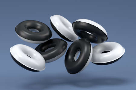 Colorful inflatable rings flying on black and white background. 3D render of summer vacation concept...