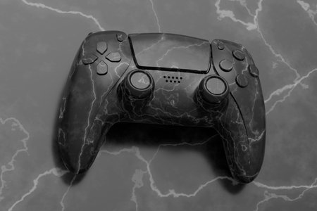 Realistic video game joystick with black marble texture on black background. 3D render of streaming...