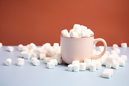 Hot cocoa with marshmallows or coffee in ceramic cup on white background. Autumn and Winter mood concept. Time for relax.の素材