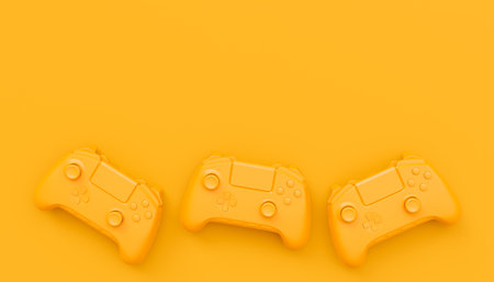 Video game joysticks or gamepads in plain monochrome yellow color background