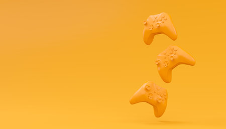 Video game joysticks or gamepads in plain monochrome yellow color background with copy space. 3D...