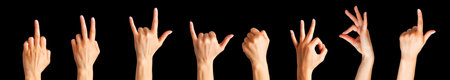 Set of woman hands showing different gestures, pointing and showing signs isolated on black backgroundの写真素材
