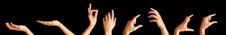 Set of woman hands showing different gestures, pointing and showing signs isolated on black backgroundの写真素材